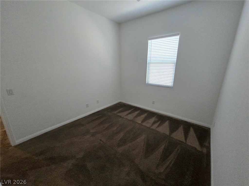 4748 Ritual Street North Las Vegas, NV 89031 - Photo 22 of 31 Well-lit room with fresh carpet, ready for your personal touches.