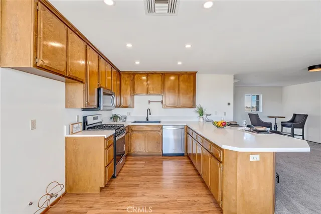 a kitchen with sink a stove and chairs