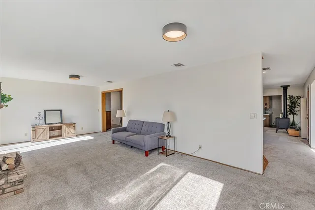 a living room with a bed furniture and a window