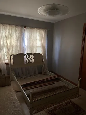 a black leather couch in a room next to a window