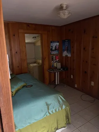 a bedroom with a bed and a book shelf