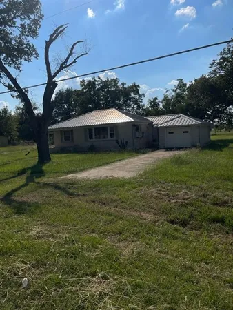 a view of a backyard of the house