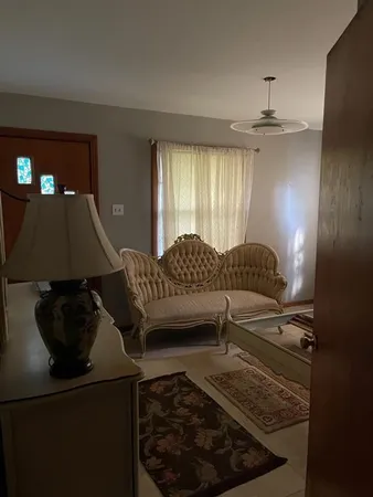 a living room with furniture and a chandelier