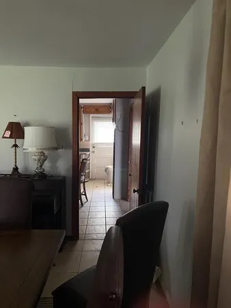 a living room with furniture and a walk in closet