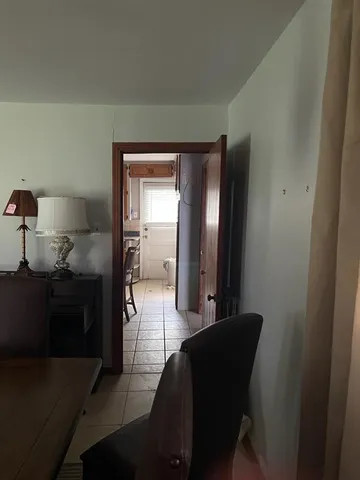 a living room with furniture and a walk in closet