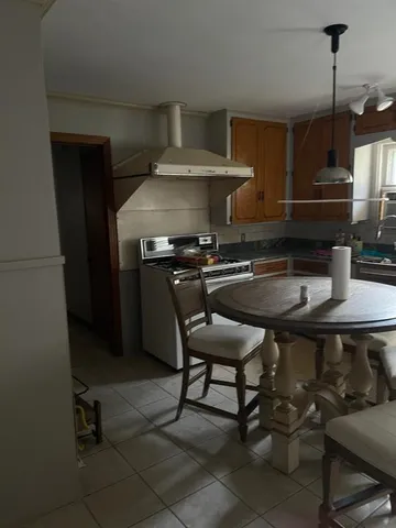 a kitchen with a table chairs and a stove