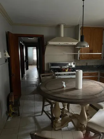 a kitchen with table and chairs