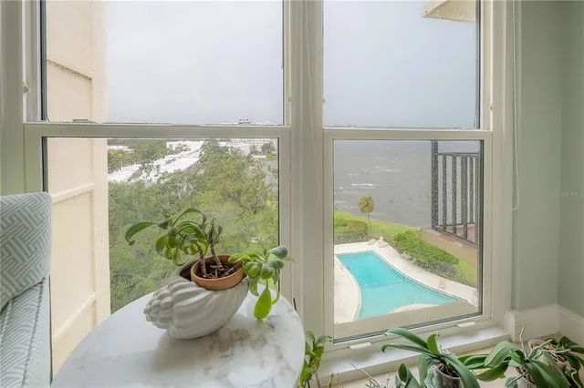 a bedroom with a bed and large window