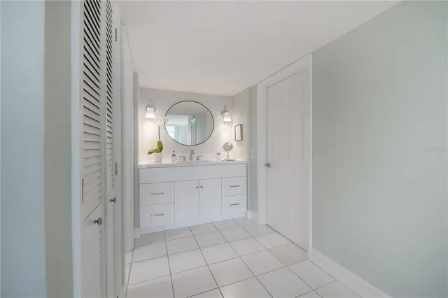 a bathroom with a double vanity sink and a mirror