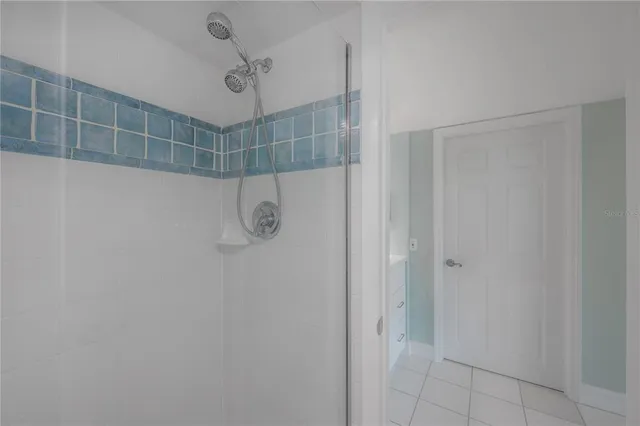 a bedroom with a large bed and windows