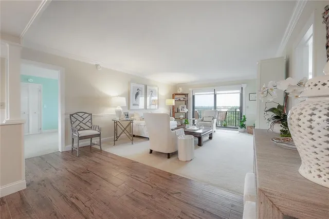 a living room with furniture and large windows