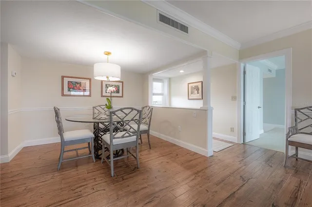 a dining room with furniture and wooden floor
