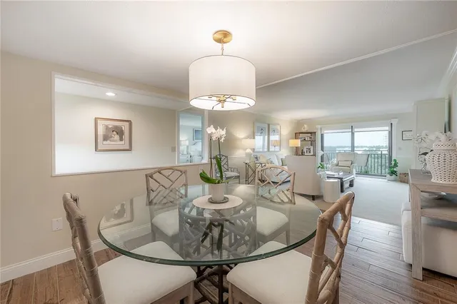 a dining room with furniture window and wooden floor