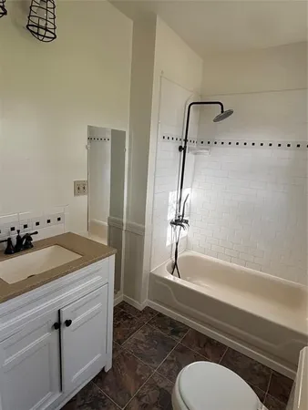 a view of empty room with wooden floor and window