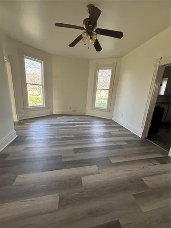a view of a ceiling fan and wooden floor