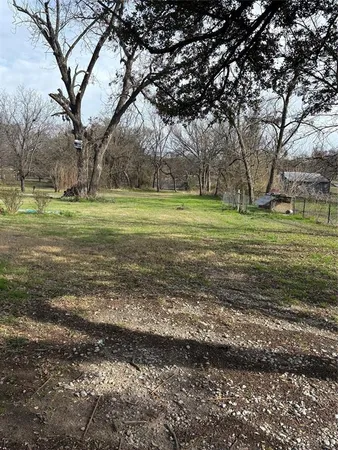 a view of a field with trees around