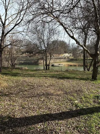a view of a yard with wooden fence