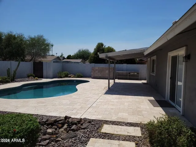 a view of a swimming pool with a chair