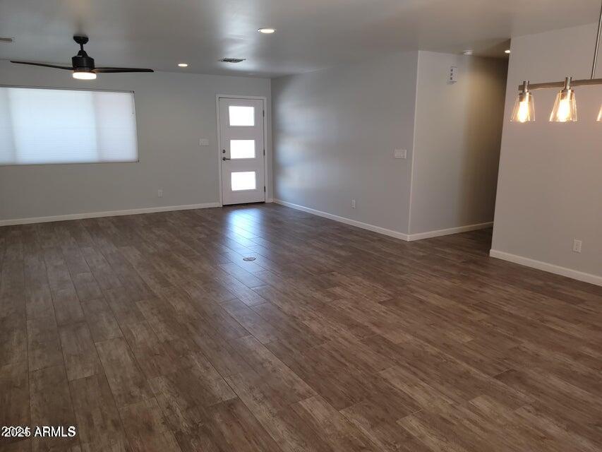 2821 East Cortez Street Phoenix, AZ 85028 - Photo 4 of 18 an empty room with wooden floor and windows