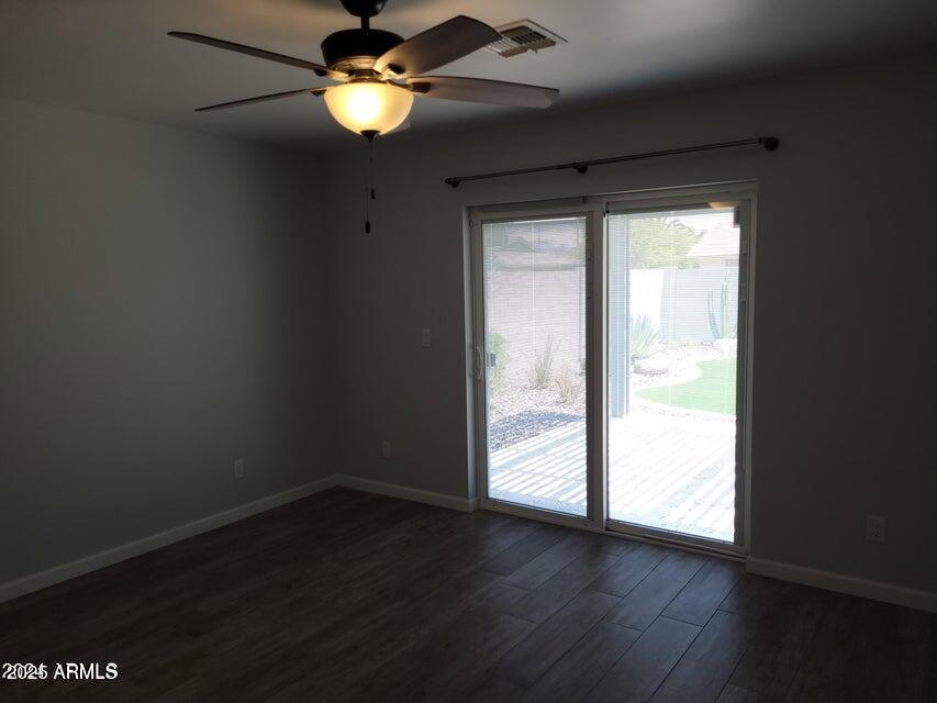 2821 East Cortez Street Phoenix, AZ 85028 - Photo 8 of 18 a view of empty room with wooden floor and fan
