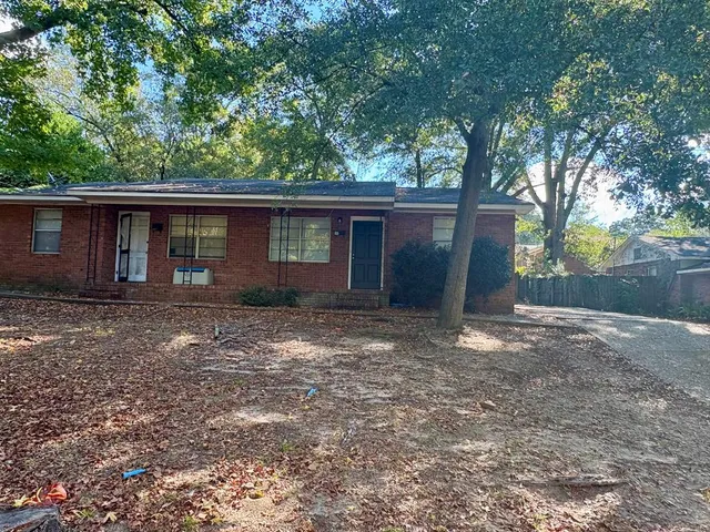 a house with trees in the background