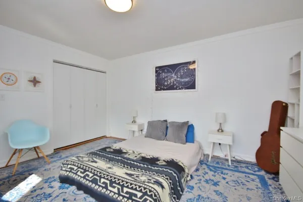 a bedroom with a bed and a chair
