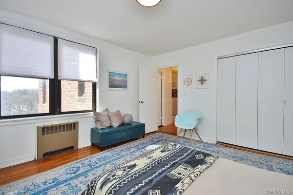 a bedroom with a bed and a large window