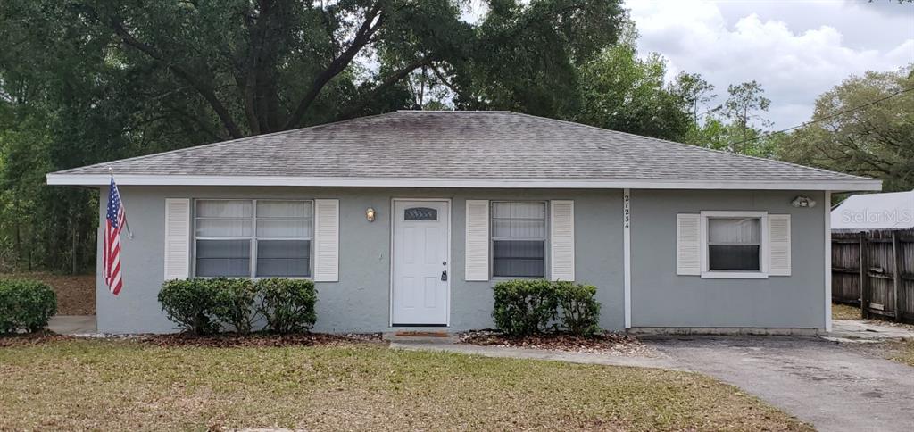 21234 Southwest Raintree Street Dunnellon, FL 34431 - Photo 1 of 1 a view of a house with backyard and garden