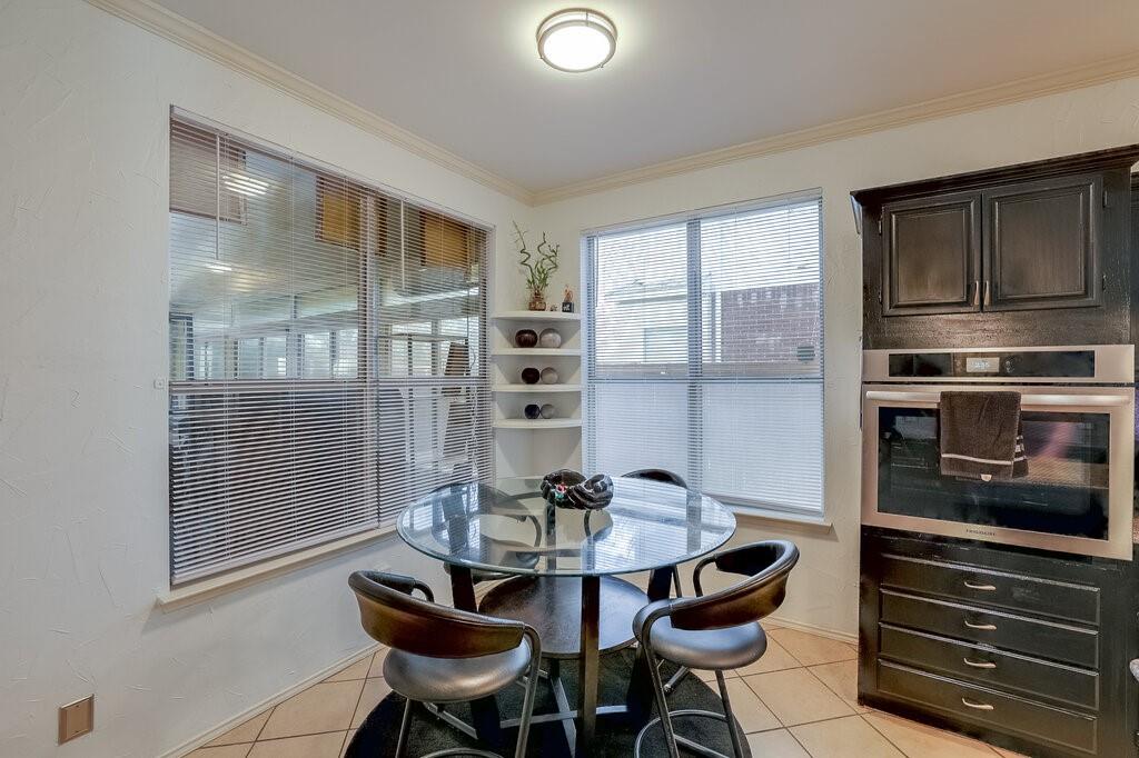 706 Gentry Drive Arlington, TX 76018 - Photo 16 of 39 a kitchen with a table chairs and a refrigerator