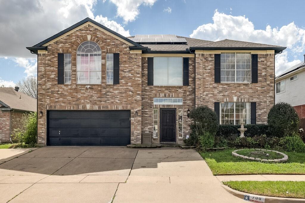 706 Gentry Drive Arlington, TX 76018 - Photo 2 of 39 a front view of a house with a yard and garage
