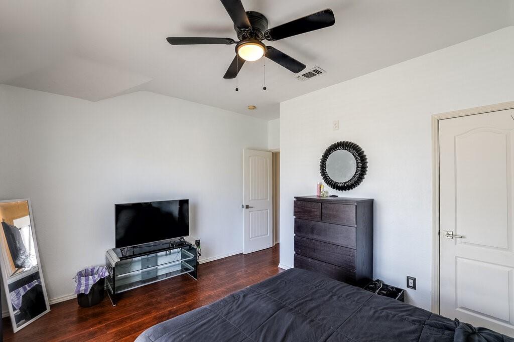 706 Gentry Drive Arlington, TX 76018 - Photo 22 of 39 a bedroom with a bed and a flat screen tv