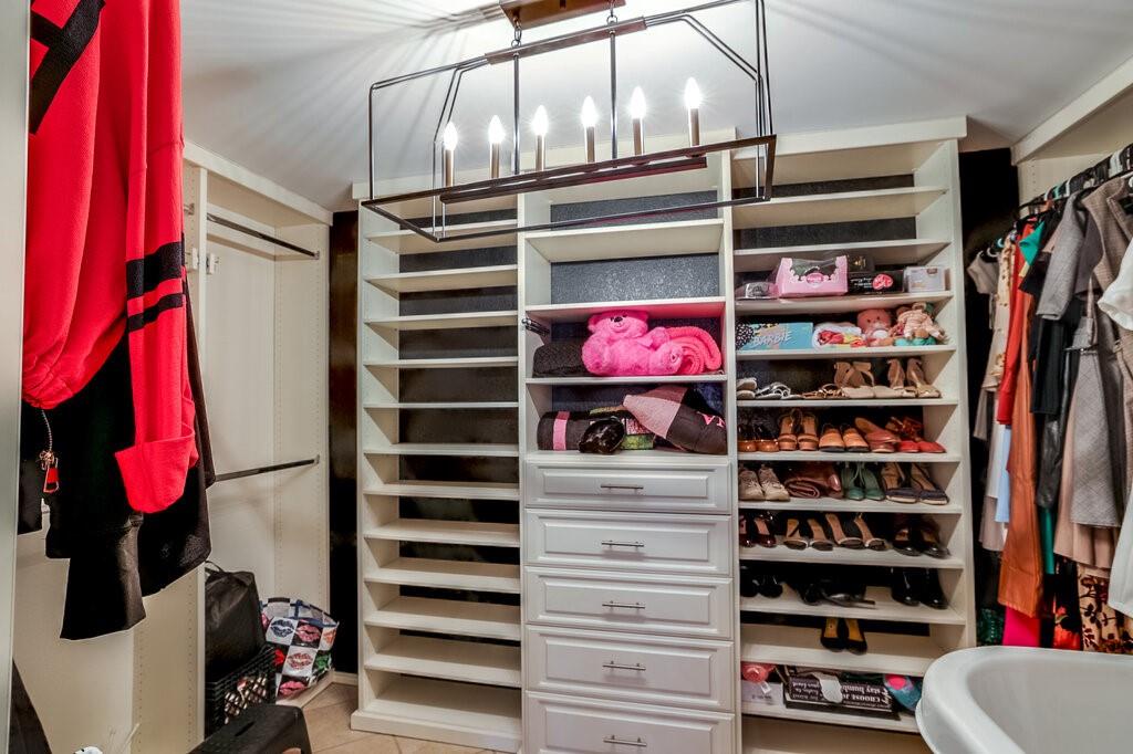 706 Gentry Drive Arlington, TX 76018 - Photo 26 of 39 a view of walk in closet with clothes and shoes