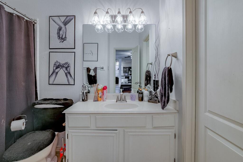 706 Gentry Drive Arlington, TX 76018 - Photo 28 of 39 a bathroom with a sink a toilet and a mirror