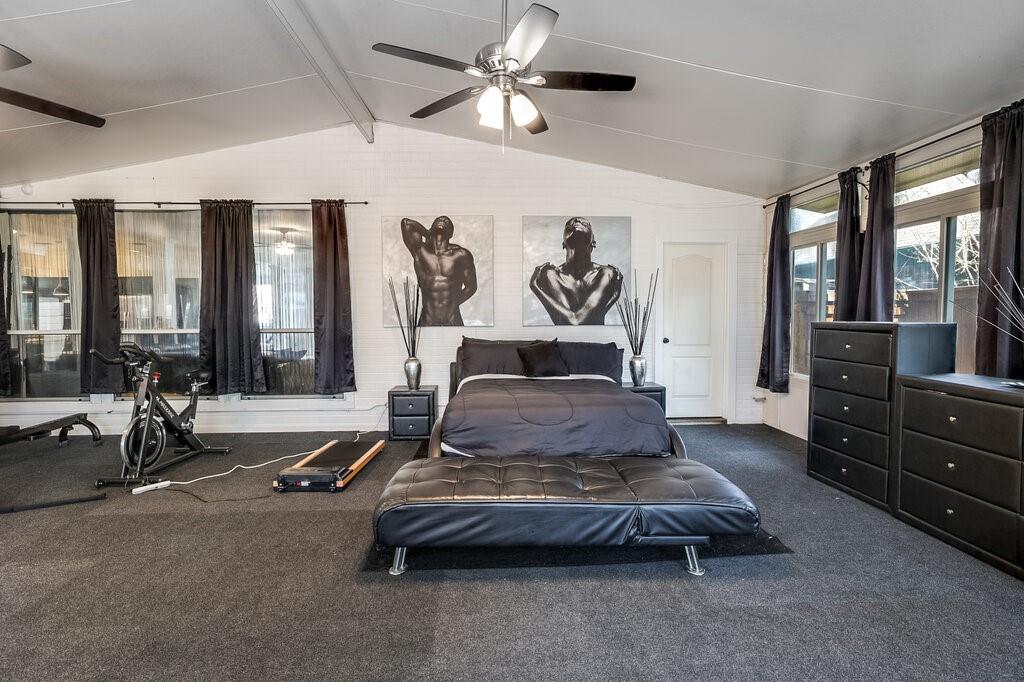 706 Gentry Drive Arlington, TX 76018 - Photo 33 of 39 a bedroom with a bed and large window with the view of cabinet