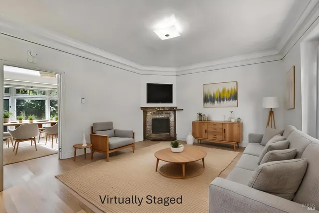 a living room with furniture a fireplace and a flat screen tv