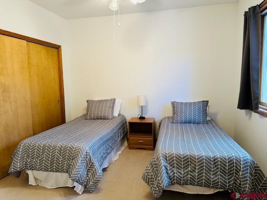 105 Indian Hill Road Mosca, CO 81146 - Photo 12 of 38 Second bedroom with twin beds. Large picture window with mountain views.
