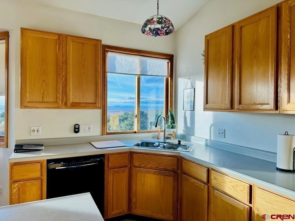105 Indian Hill Road Mosca, CO 81146 - Photo 22 of 38 Love the window by the kitchen sink! Oak cabinets.