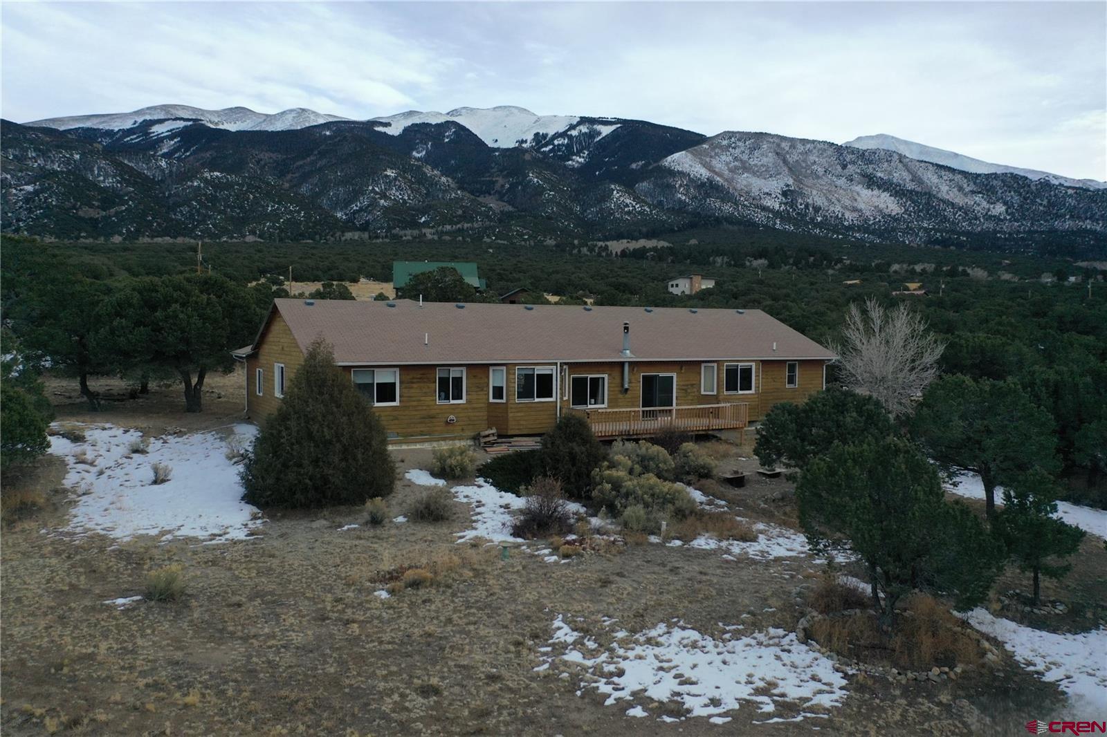 105 Indian Hill Road Mosca, CO 81146 - Photo 3 of 38 Ranch style home is situated on a 1.28-acre lot with a nice walkout deck facing west. Experience amazing sunsets and Sand Dune views.