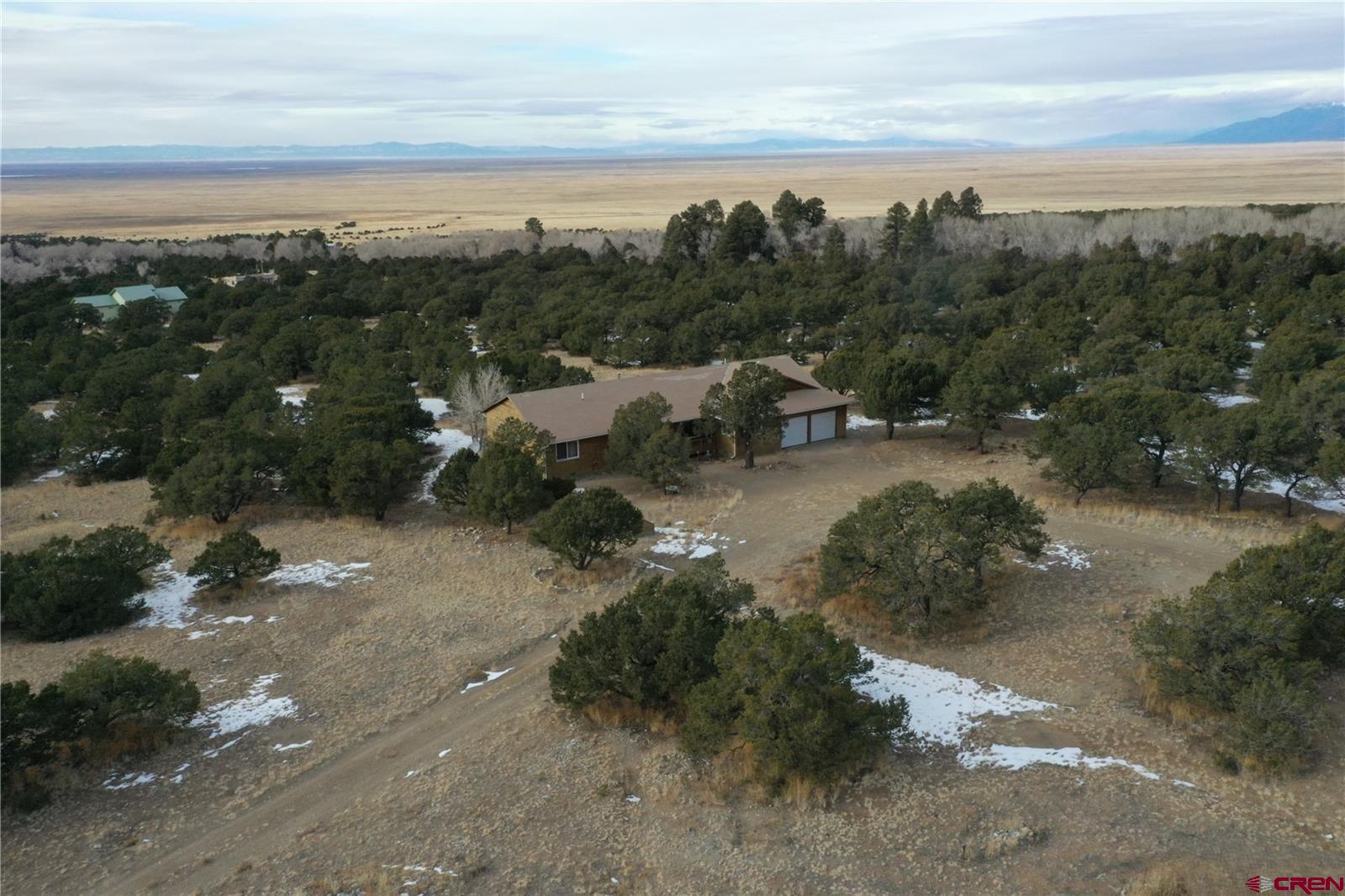105 Indian Hill Road Mosca, CO 81146 - Photo 35 of 38 Nice aerial view of the home, driveway, and valley.