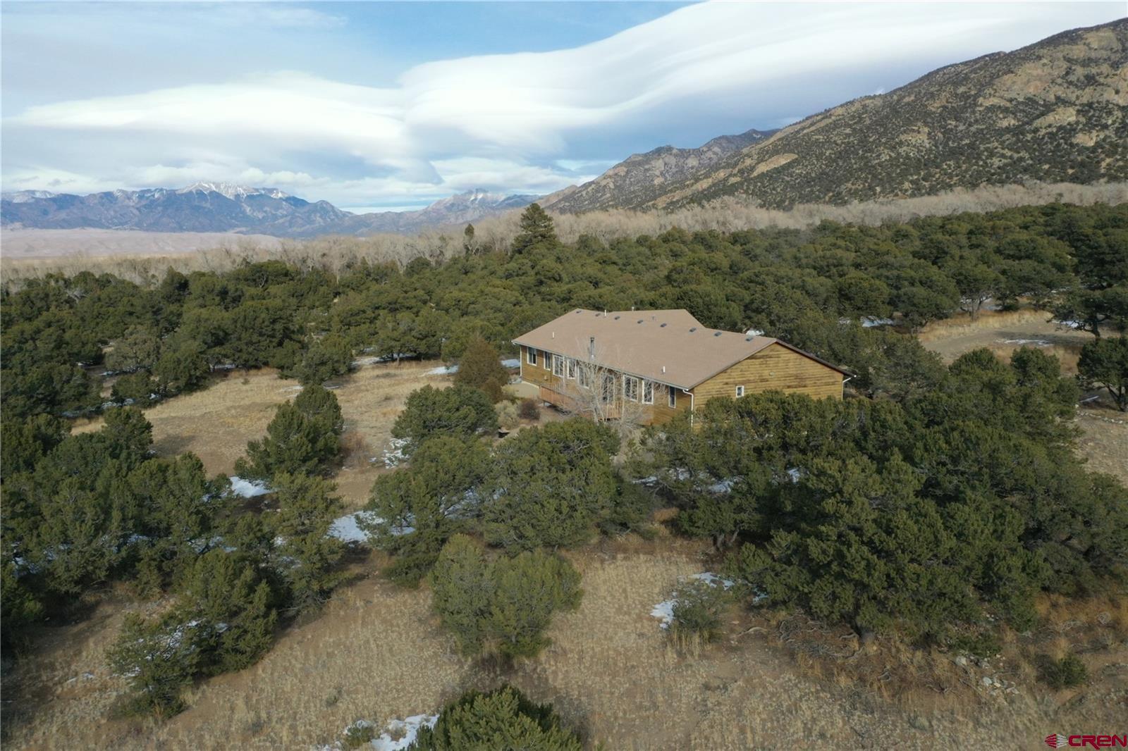 105 Indian Hill Road Mosca, CO 81146 - Photo 5 of 38 The Sand Dunes are just over the horizon to the north of the home. The lot has a gentle slope.