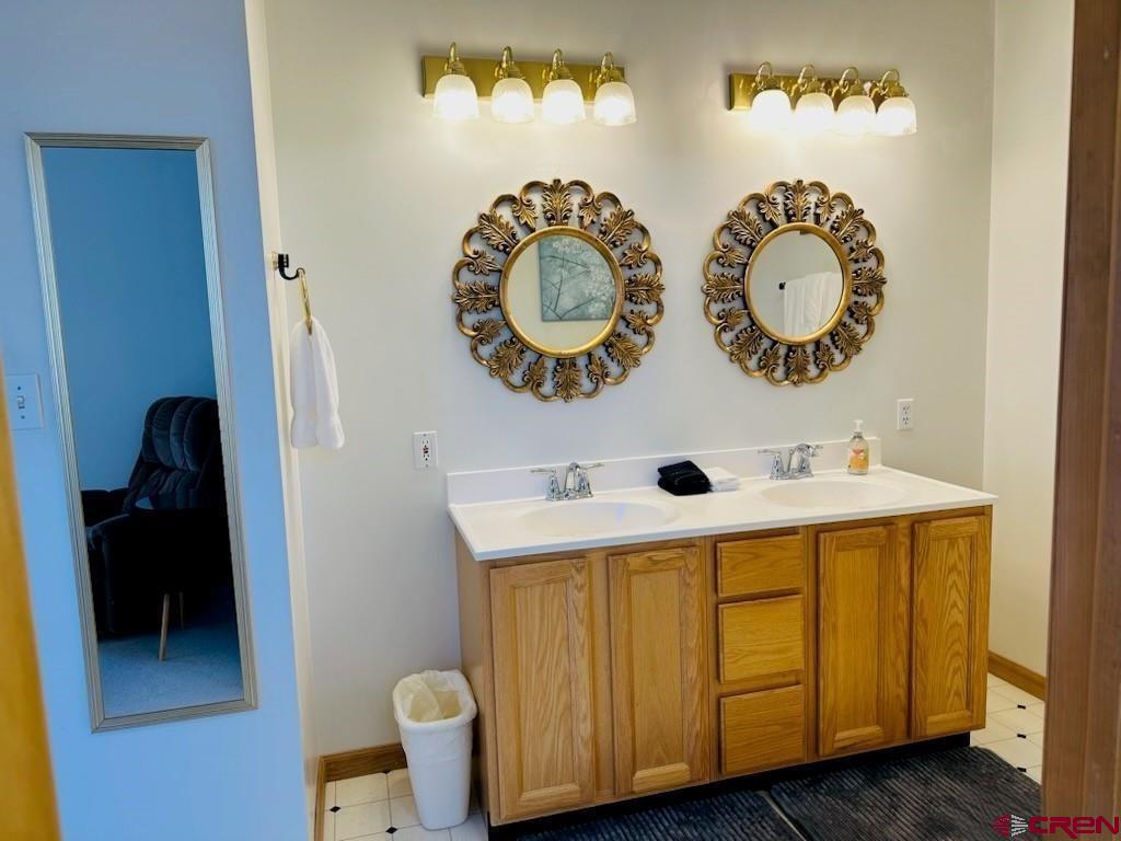 105 Indian Hill Road Mosca, CO 81146 - Photo 8 of 38 Primary bathroom has dual sinks with elegant top of the line fixtures.