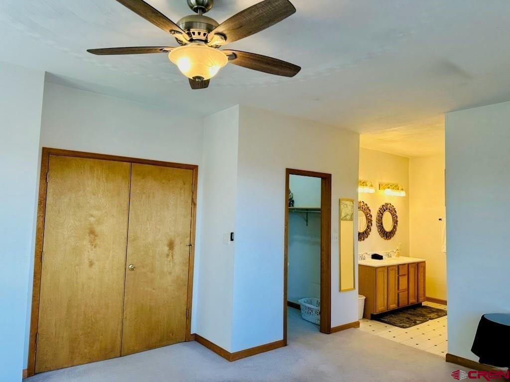 105 Indian Hill Road Mosca, CO 81146 - Photo 10 of 38 Primary bedroom with French door entry doors, walk-in closet, and private bathroom amenities.