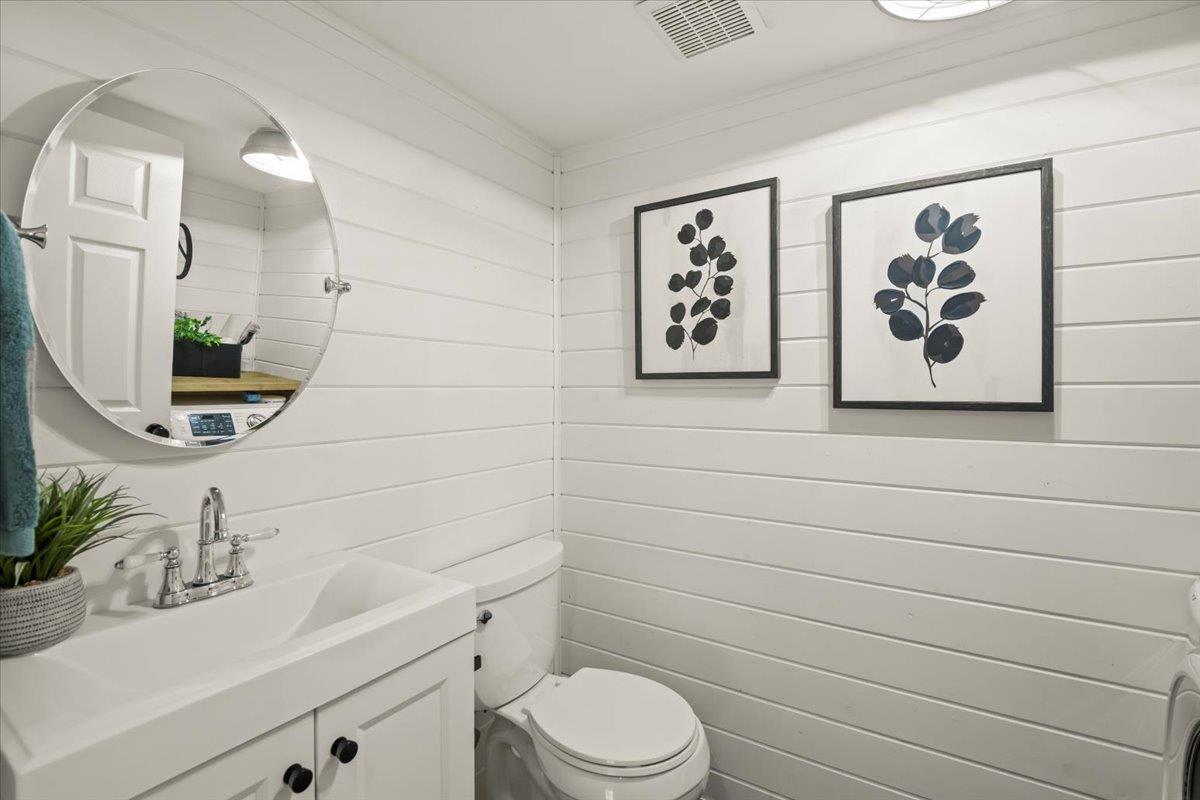 16761 San Luis Way Morgan Hill, CA 95037 - Photo 12 of 35 a bathroom with a toilet sink and mirror