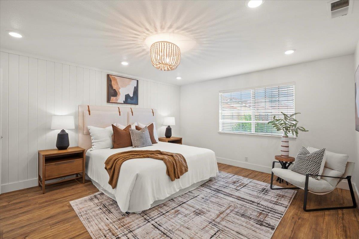 16761 San Luis Way Morgan Hill, CA 95037 - Photo 15 of 35 a spacious bedroom with a bed and wooden floor