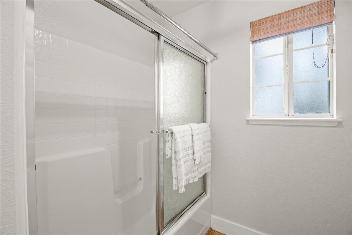 16761 San Luis Way Morgan Hill, CA 95037 - Photo 17 of 35 a bathroom with a glass shower door