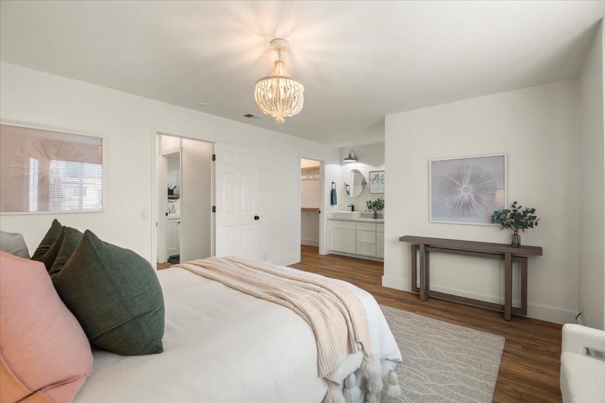 16761 San Luis Way Morgan Hill, CA 95037 - Photo 21 of 35 a spacious bedroom with a bed and a chandelier