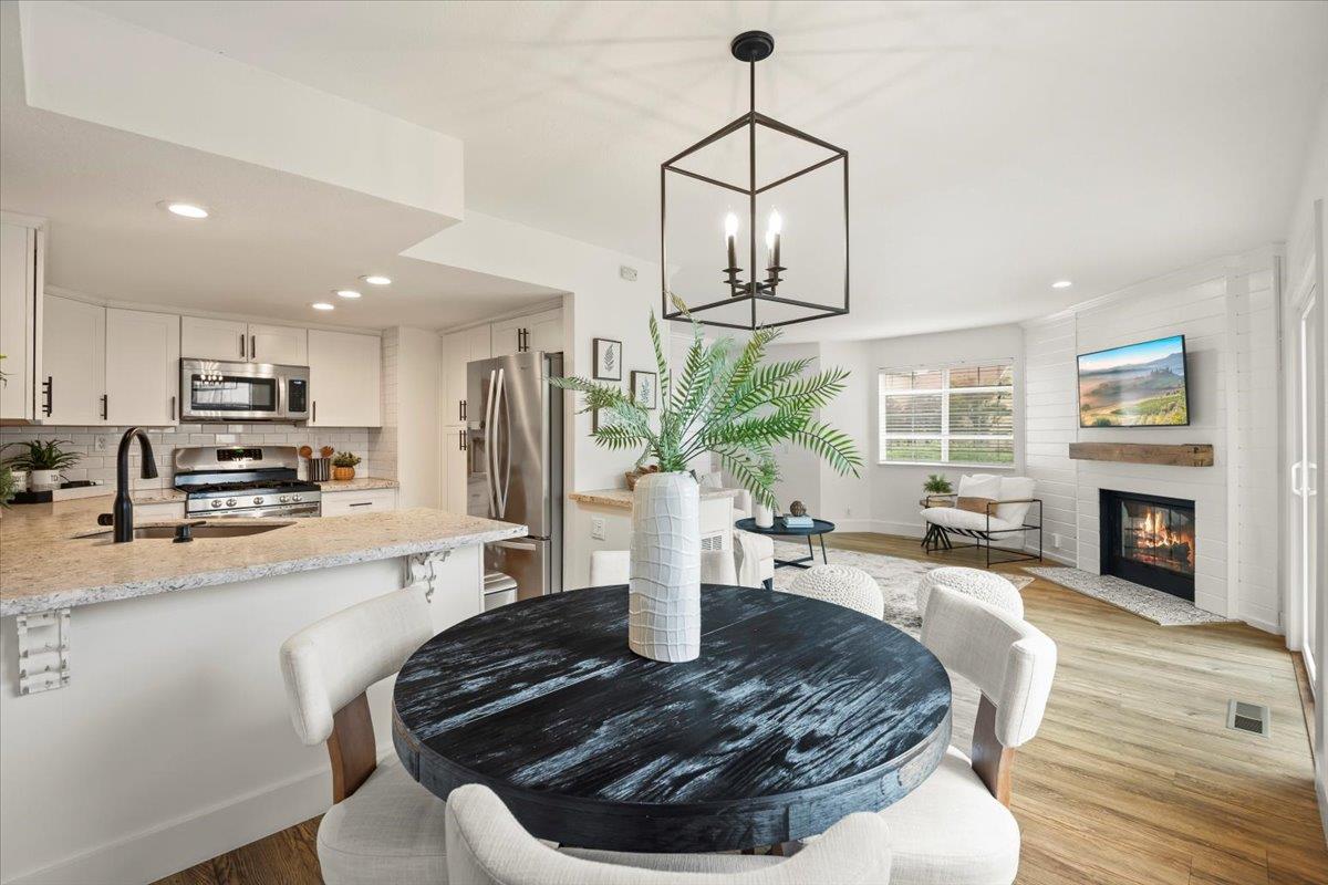 16761 San Luis Way Morgan Hill, CA 95037 - Photo 7 of 35 a living room with furniture a fireplace and a kitchen view