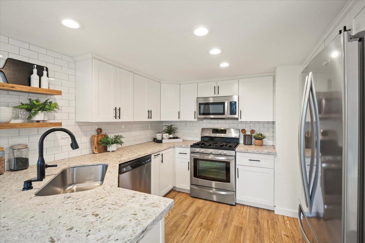 16761 San Luis Way Morgan Hill, CA 95037 - Photo 9 of 35 a kitchen with granite countertop a sink stainless steel appliances and wooden floor