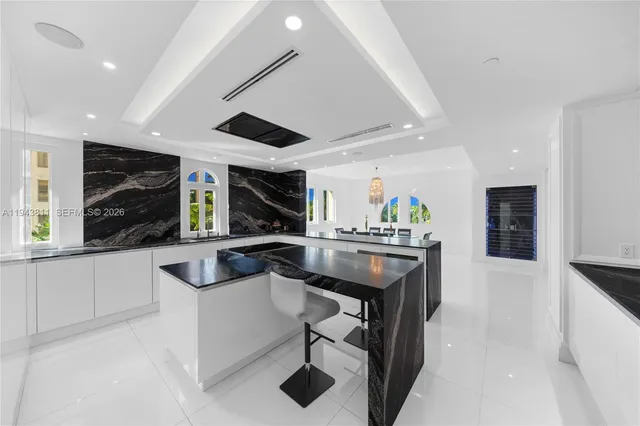 a bathroom with a double vanity sink a mirror and a bathtub