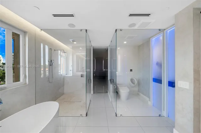a bathroom with a shower and a glass door